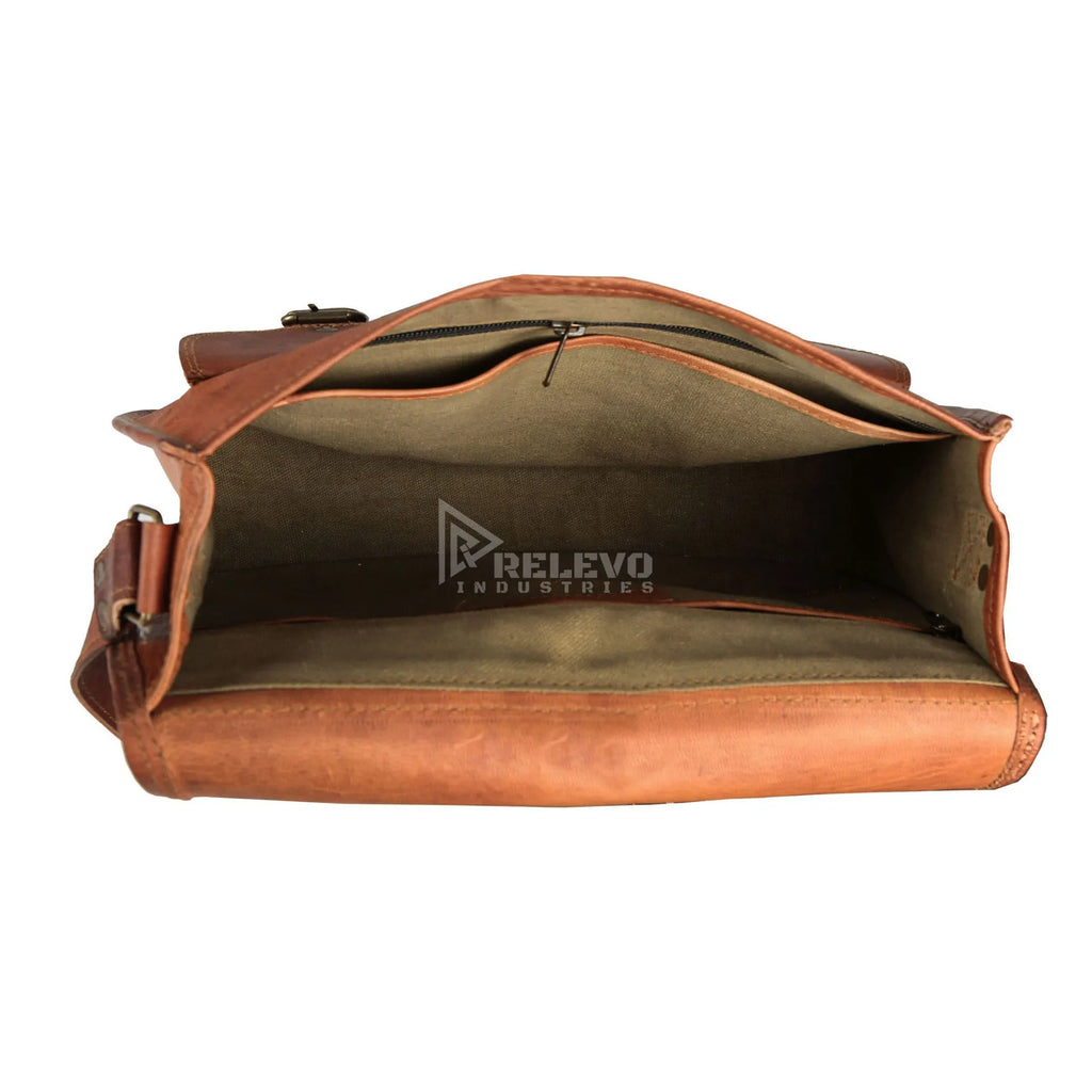 Open interior of brown leather designer shoulder bag with canvas lining and organized zipper compartments.