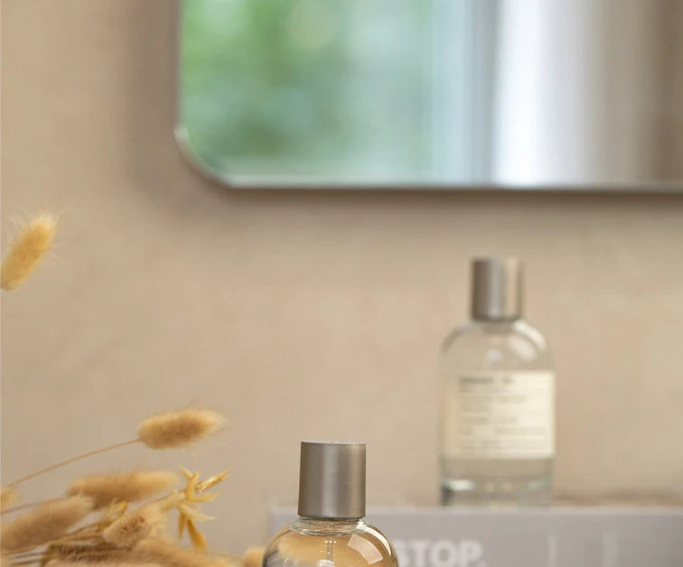 100ml sandalwood fruity unisex Eau de Toilette in a clear glass cylindrical spray bottle with a minimalist silver cap.