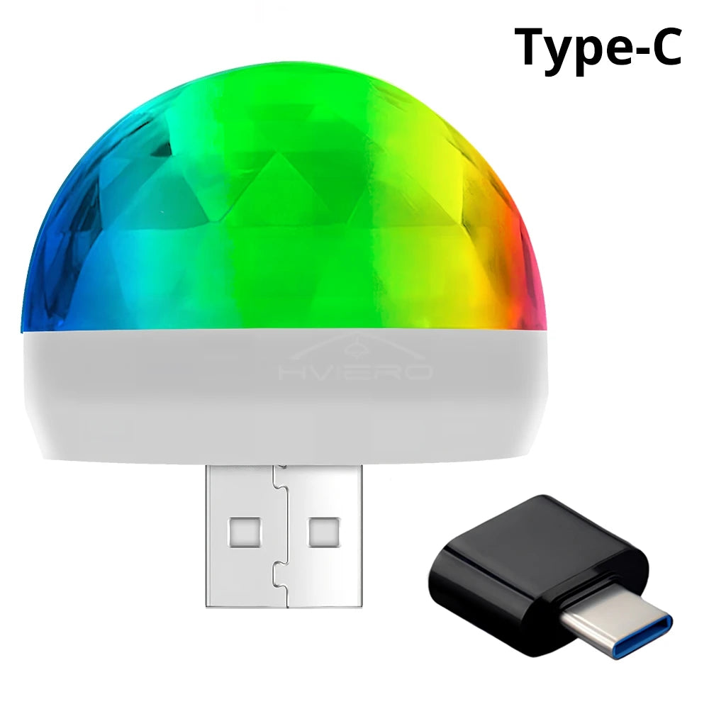 Portable USB disco ball light with a faceted multicolored dome and a USB-C adapter for ambient color lighting.