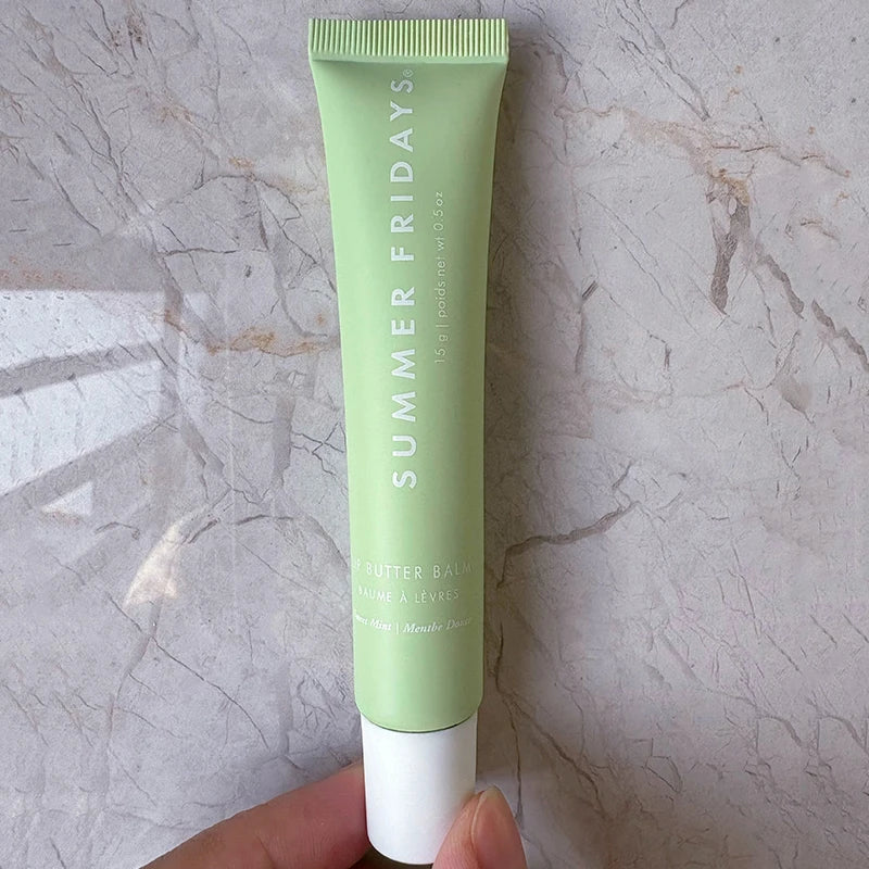 Summer Fridays Lip Butter Balm in a light green squeeze tube, moisturizing lip makeup for smooth, soft, glossy lips.