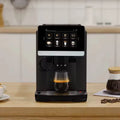 Black automatic espresso coffee machine with large touchscreen display brewing fresh coffee in a glass on kitchen counter.