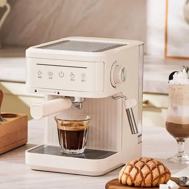 Compact off-white espresso machine with integrated milk frother, digital touch controls, and removable drip tray.