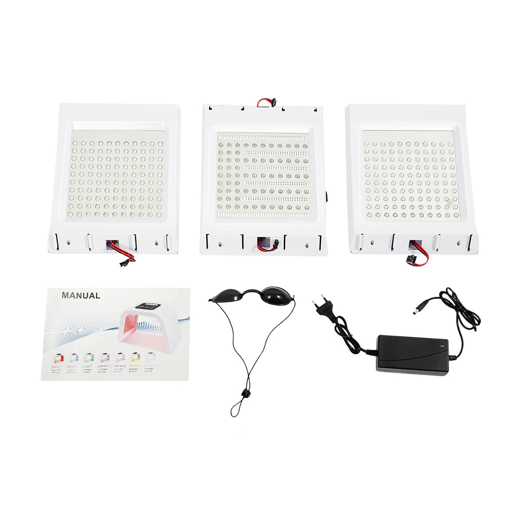 Three white LED light therapy panels, protective goggles, power adapter, and manual for skincare treatment.