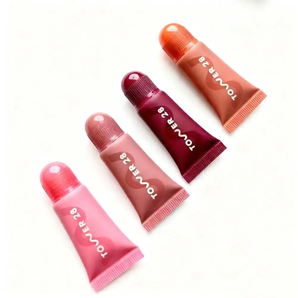 Tower 28 4pc lip jelly set: hydrating tinted gloss tubes in pink, mauve, berry, and peach with mirror-shine finish.