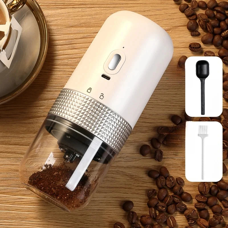 Portable white electric coffee grinder with clear glass container, silver textured grip, and included cleaning tools.