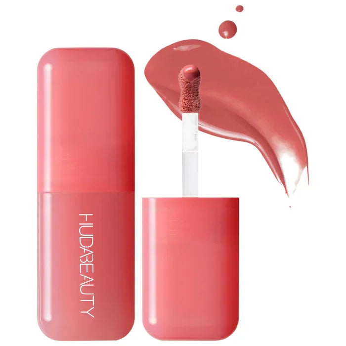 Huda Beauty hydrating lip and cheek tint stick in a creamy rose pink shade with a doe-foot applicator and texture swatch.