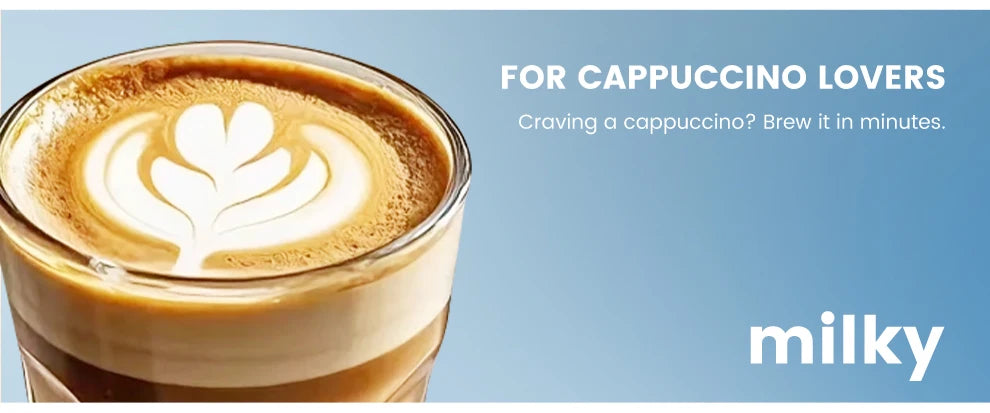 Milky brand glass cup filled with fresh cappuccino featuring heart latte art, perfect for quick coffee brewing.