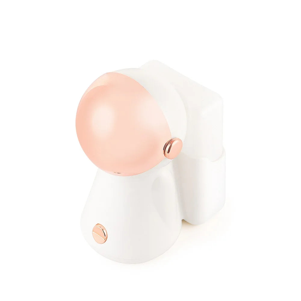 White and rose gold astronaut-shaped nano face steamer with light therapy for deep pore cleansing and skin brightening.