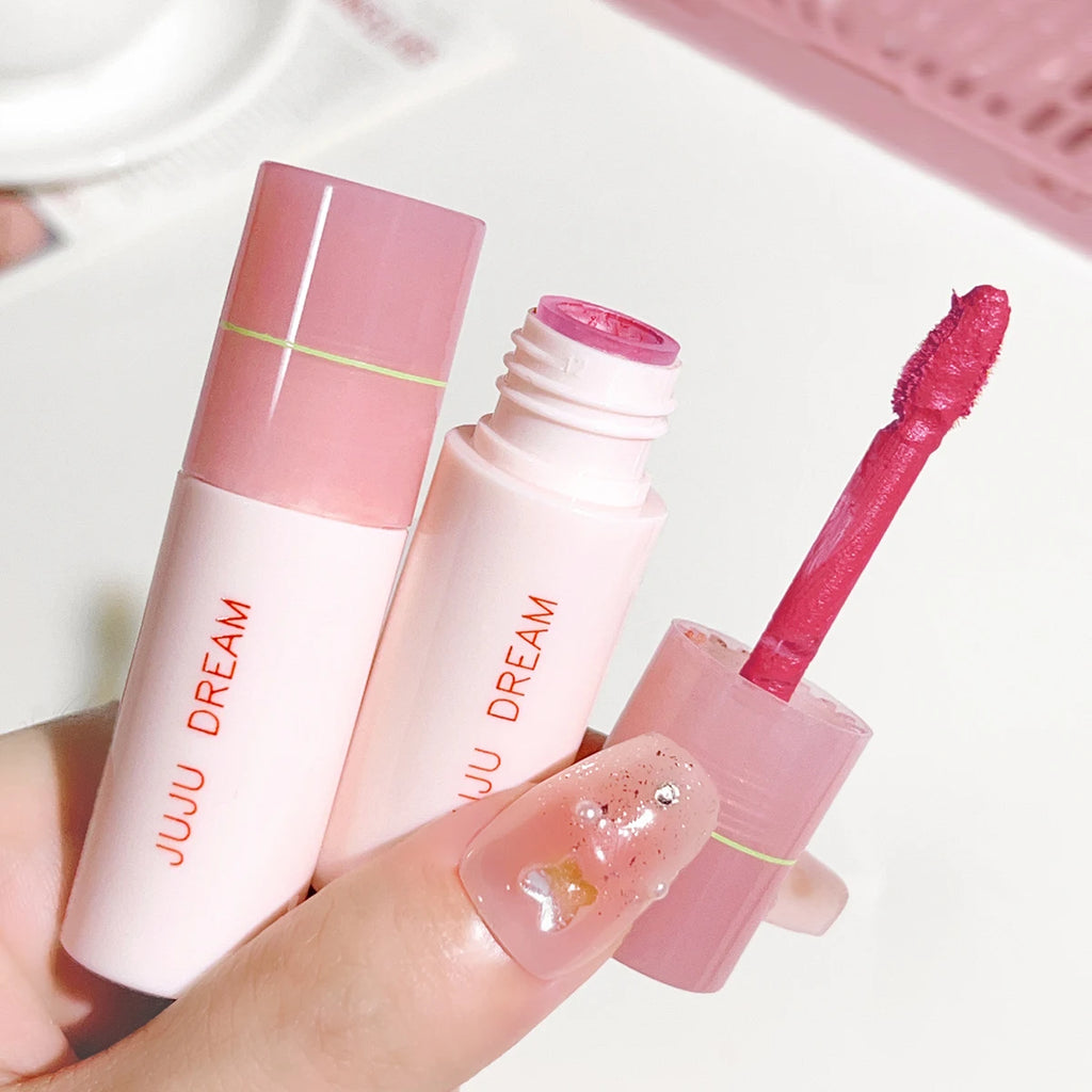 JUJU DREAM matte lip glaze in a soft pink tube with a vibrant velvet pink applicator wand, non-stick makeup finish.