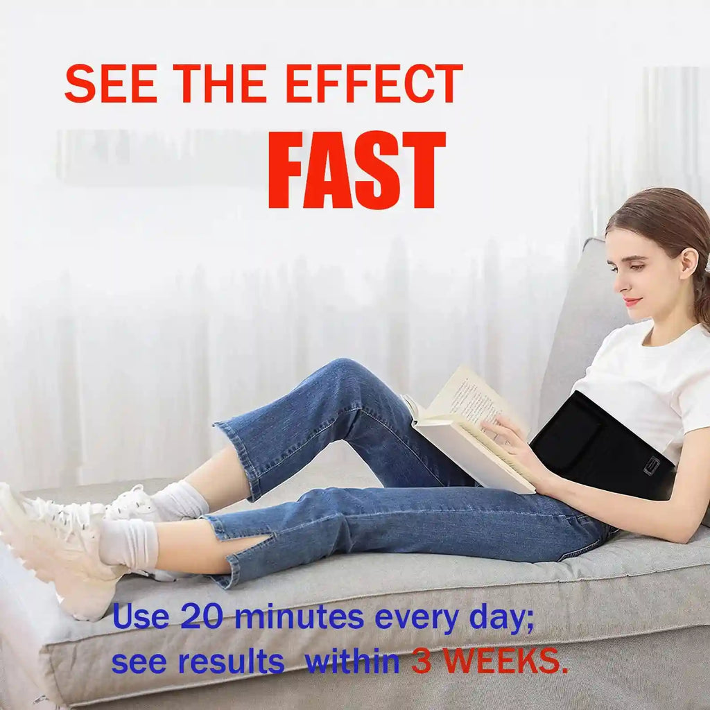Woman reading on a couch wearing a black LED light therapy belt around her waist.