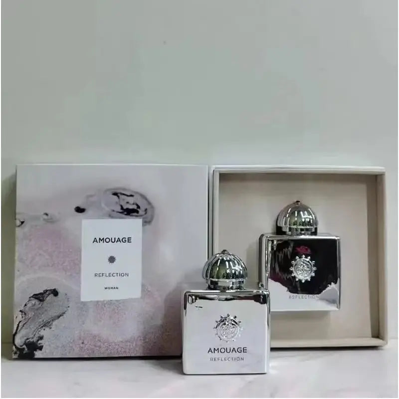 Amouage Reflection Woman EDP: 100ml floral chypre fragrance in a sleek, silver square bottle with a rounded chrome cap.