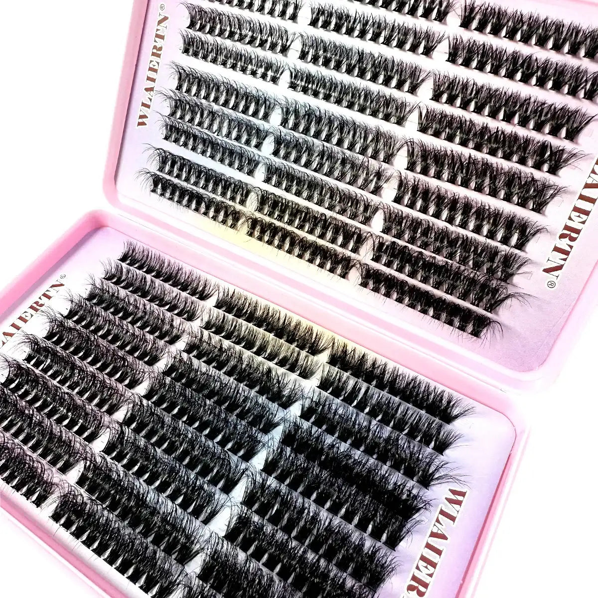 Rows of black individual false eyelash clusters arranged in a two-part pink plastic storage tray for beauty use.