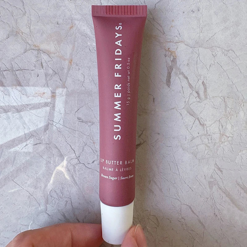 Summer Fridays Lip Butter Balm in Brown Sugar: a moisturizing, smooth beige-tinted lip treatment in a soft tube.