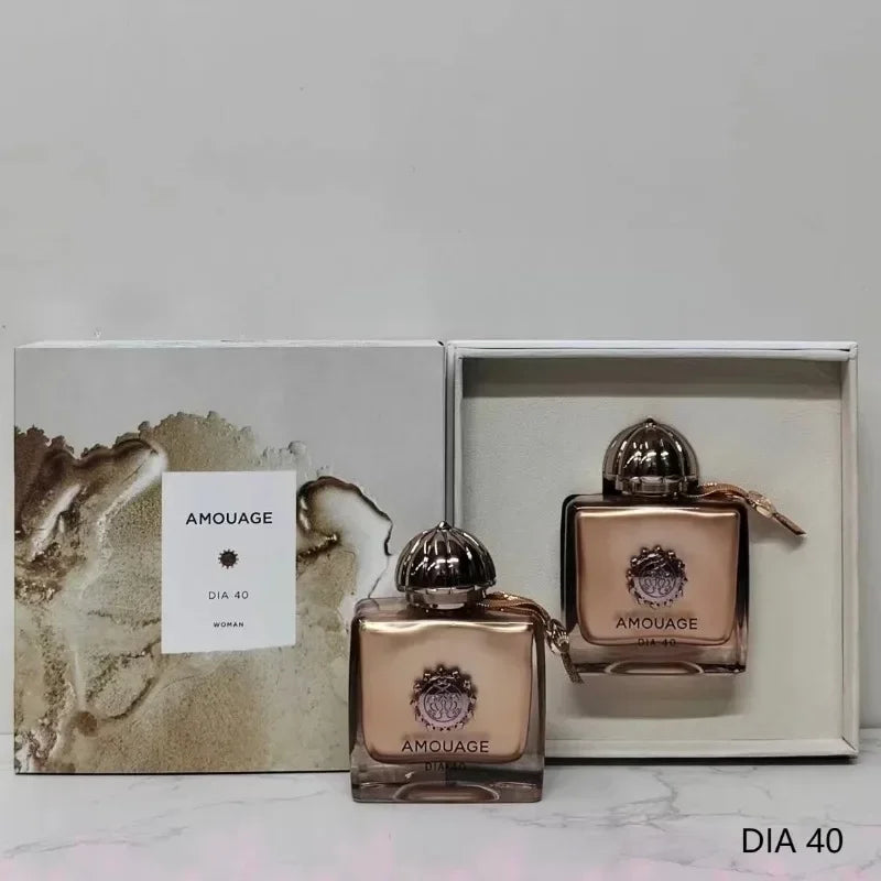 Amouage Dia 40 Woman perfume set with rose-gold metallic bottles and elegant gift box in a luxury fragrance display.