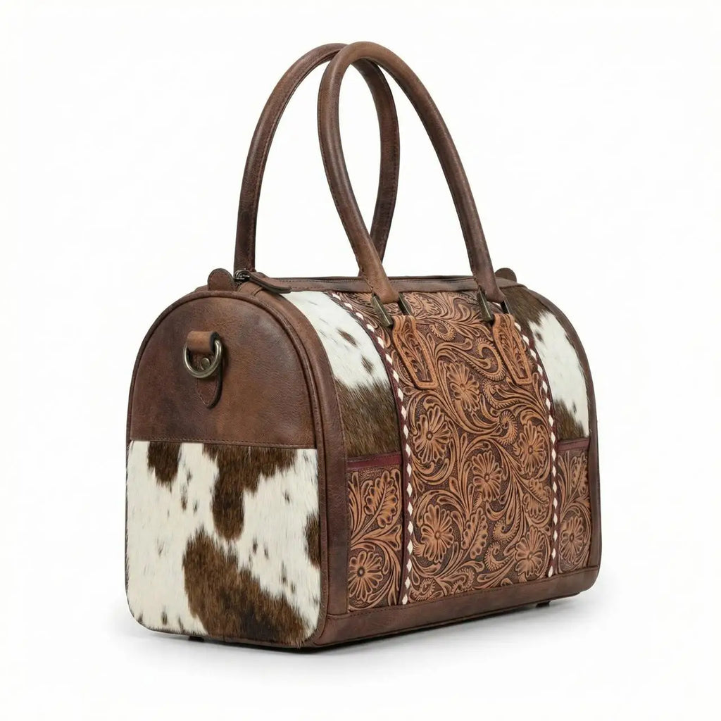 Mini western duffel bag in brown leather with floral tooling, cowhide panels, and dual top handles for travel.
