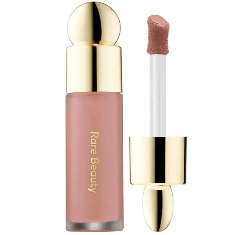 Rare Beauty rose liquid blush and lip stain with gold cap, long-lasting matte finish applicator.