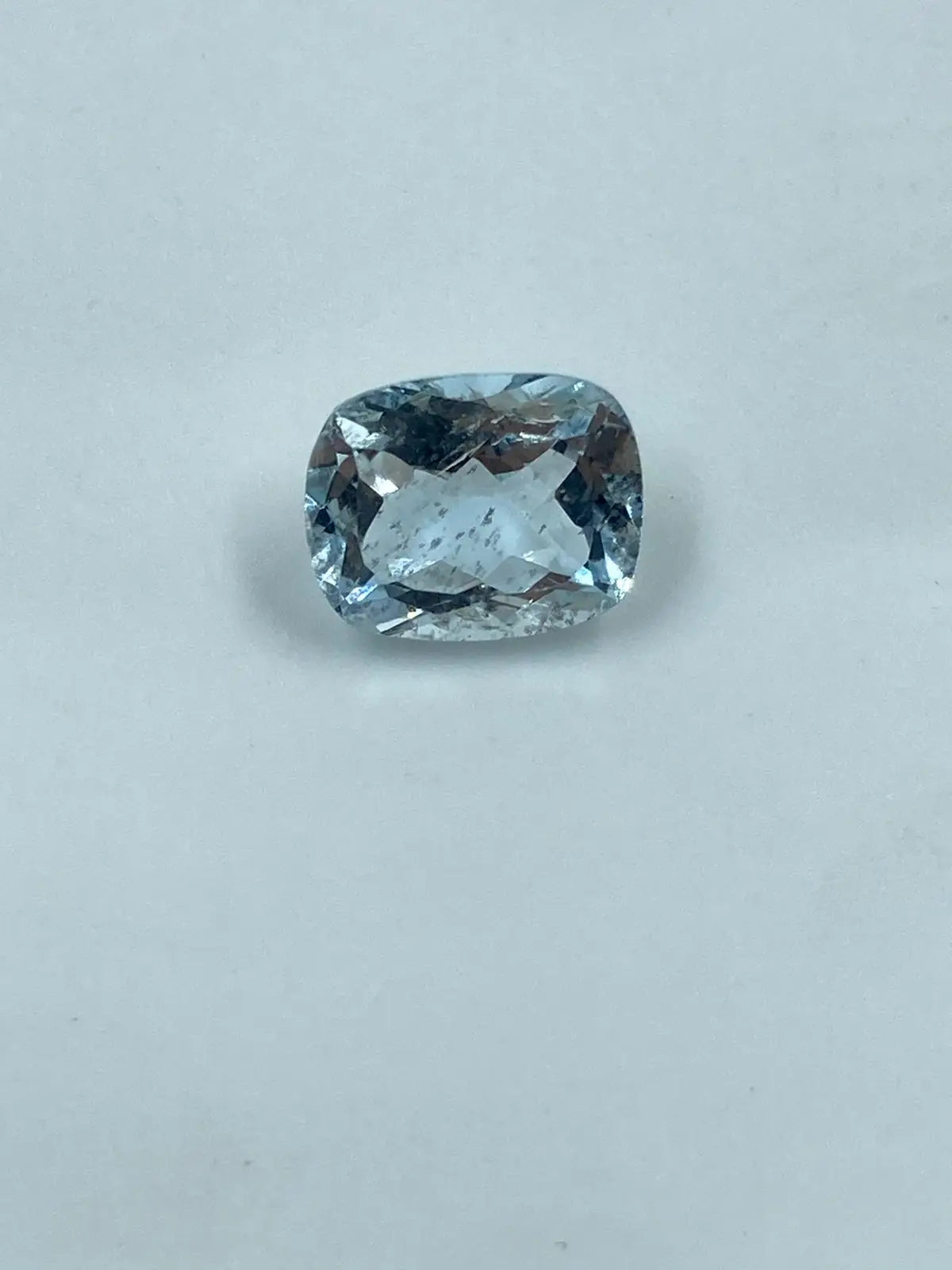 Sky-blue cushion-cut loose gemstone with faceted oval look