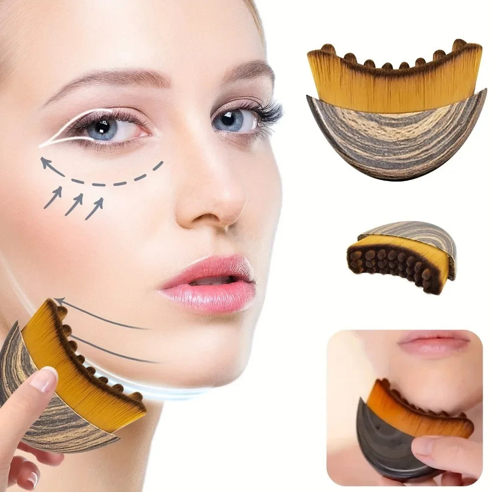 Crescent-shaped wooden face contouring brush with soft golden-brown bristles being used to massage the jawline.