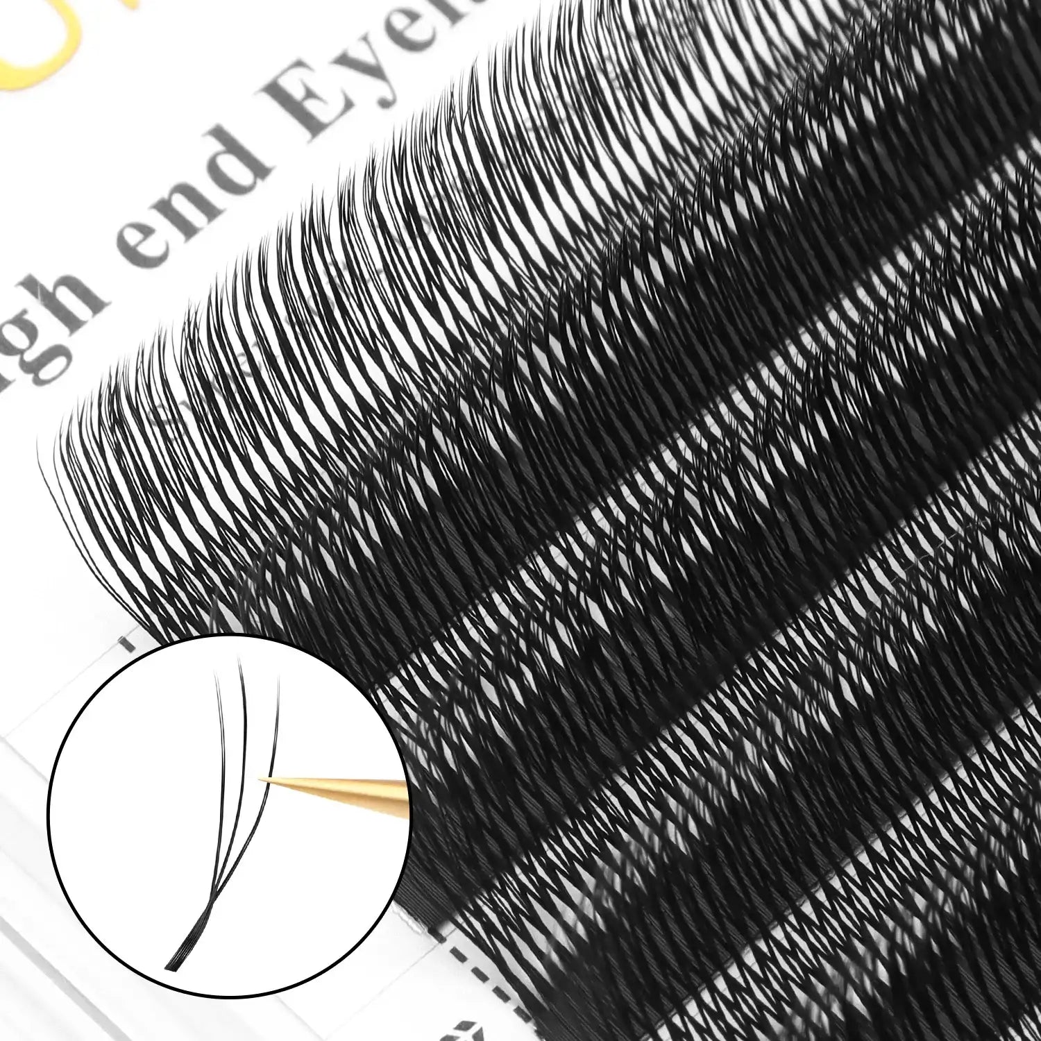 Black volume eyelash extensions on adhesive strips for professional application, showing a three-lash fan detail.