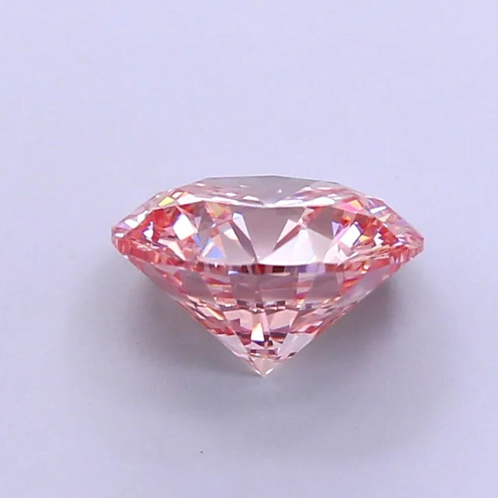 Oval pink cultured diamond gemstone with faceted pavilion