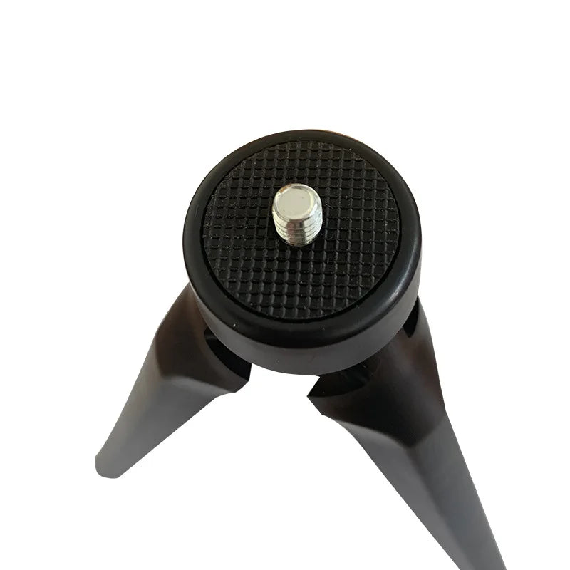 Small black plastic tabletop tripod with a circular rubberized mount and a central metal screw for mounting cameras.