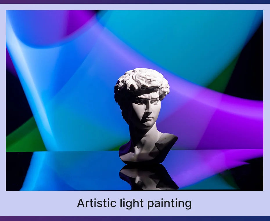 White David bust sculpture illuminated by dynamic blue and purple light painting for artistic room decor.