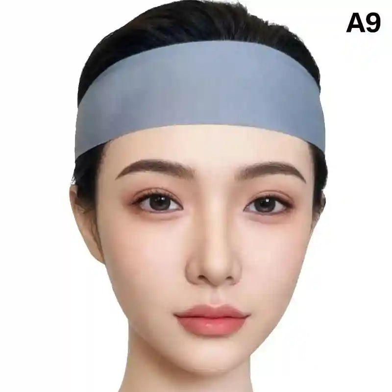 A person wearing a wide, plain light-blue fabric headband across their forehead against a white background.
