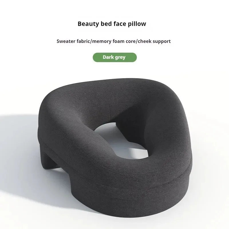 Dark grey, u-shaped memory foam face pillow for massage tables with a textured sweater-fabric cover.