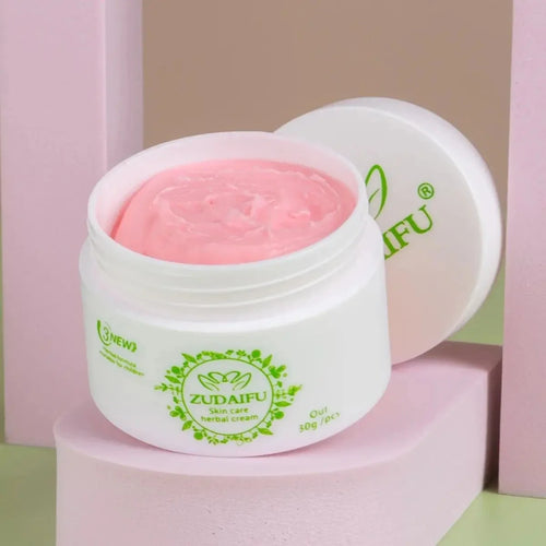Herbal body cream jar with pink cream inside, white container with green label