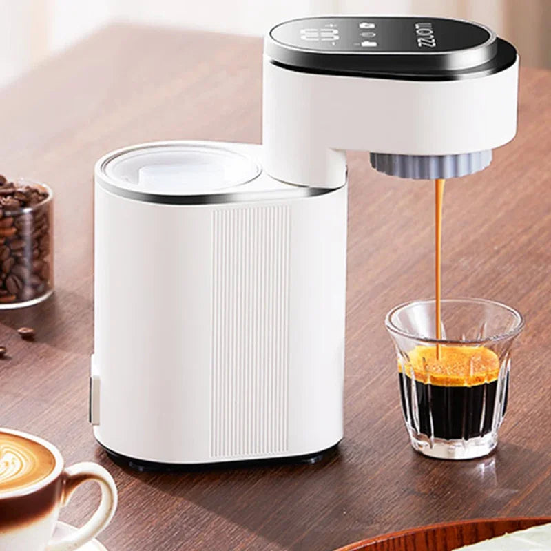 Compact white ZZUOM portable espresso coffee maker brewing into a glass on a wooden table.