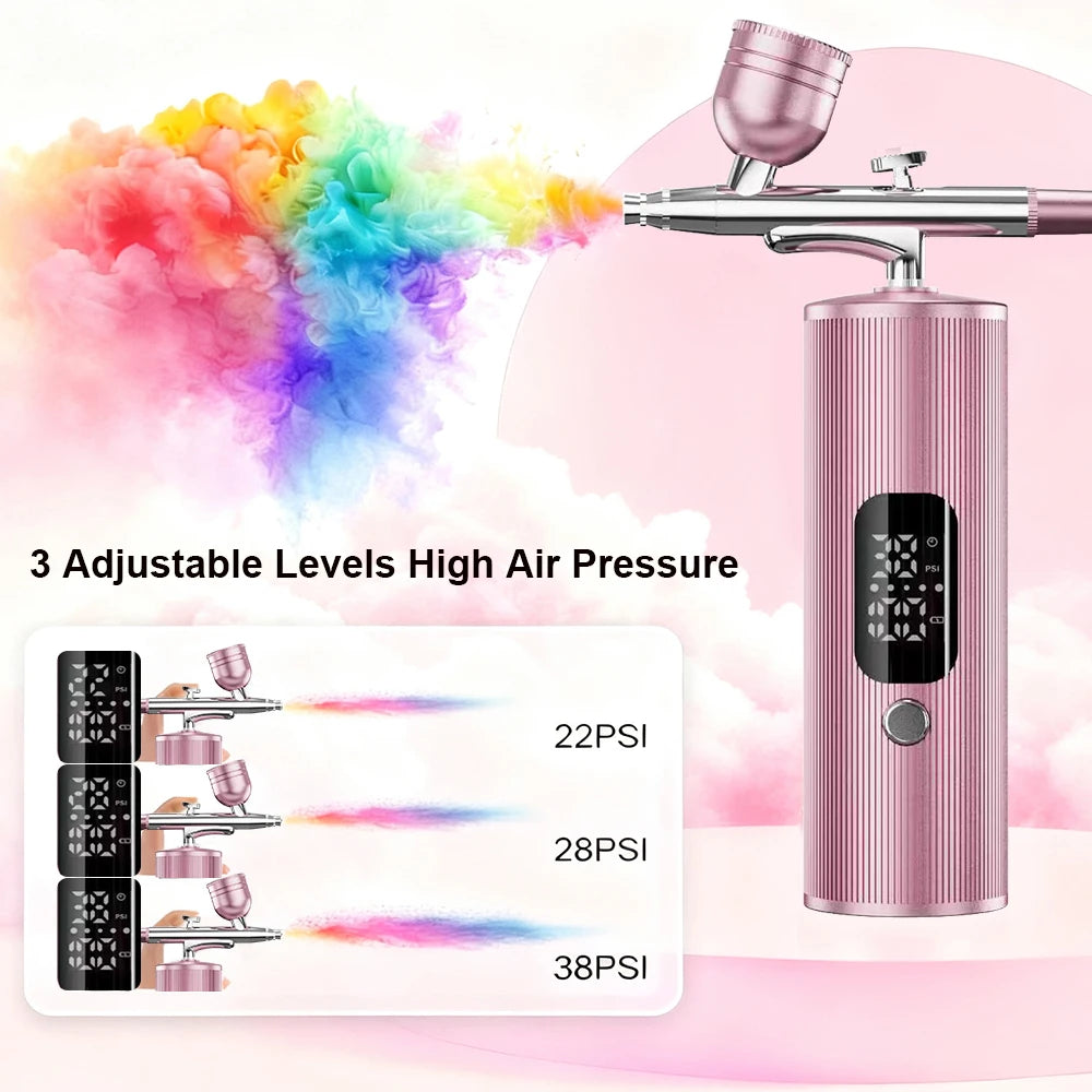 Pink portable handheld airbrush kit with 3 adjustable pressure levels for nail art, makeup, and cake decorating.