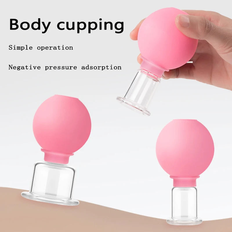 Three pink, round, rubber-topped glass vacuum cupping tools for facial or body massage shown against a white background.