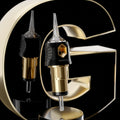 Gold and black tattoo needle cartridge with a clear plastic tip, designed for precision tattooing.