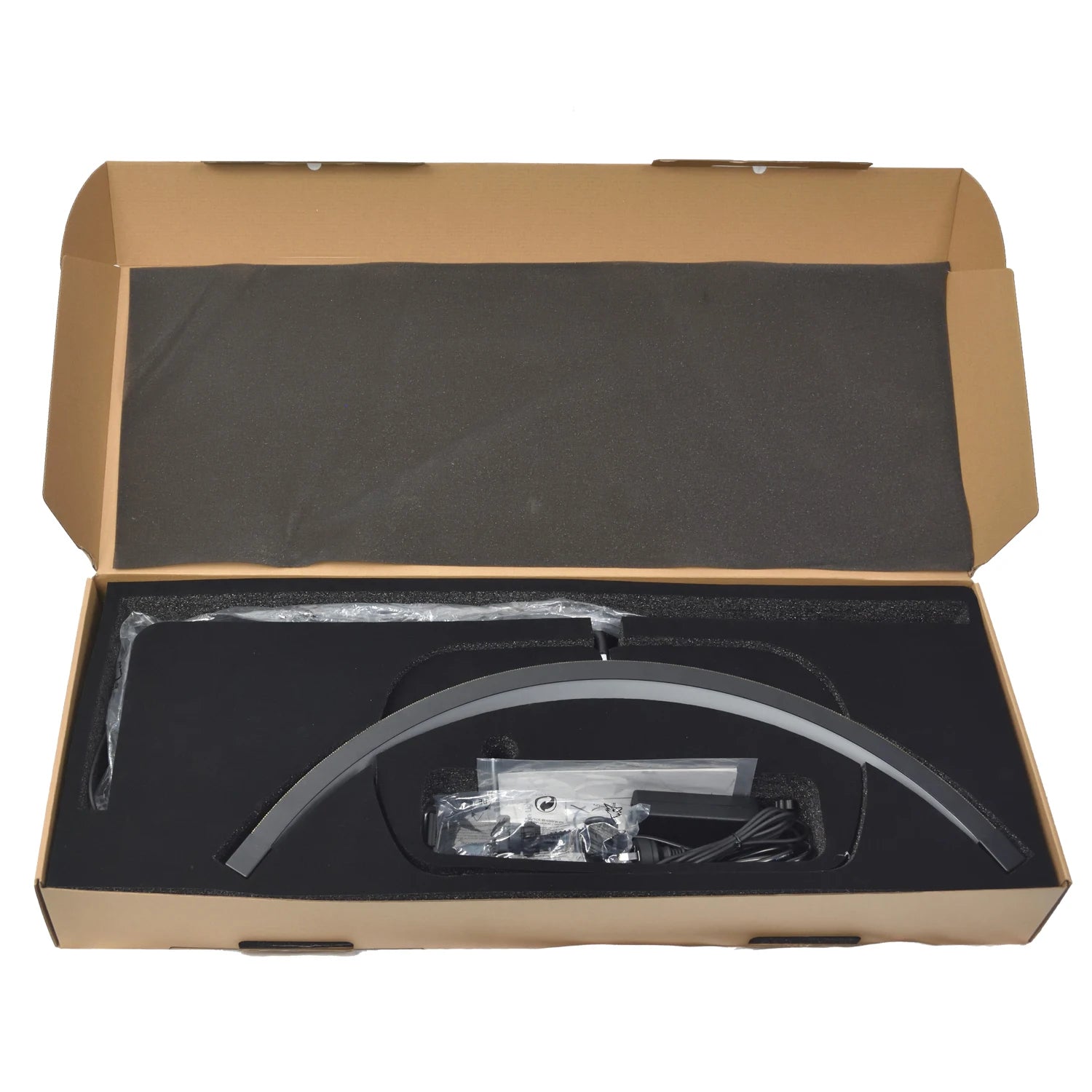 Black arc-shaped LED nail lamp with power adapter, packed in a cardboard box with foam inserts for protection.
