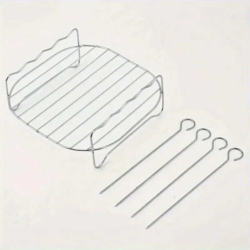 Square wire air fryer rack with four stainless skewers, laid out on a flat surface
