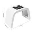 White arched LED facial therapy light machine with digital control panel and internal light matrix for skin treatment.