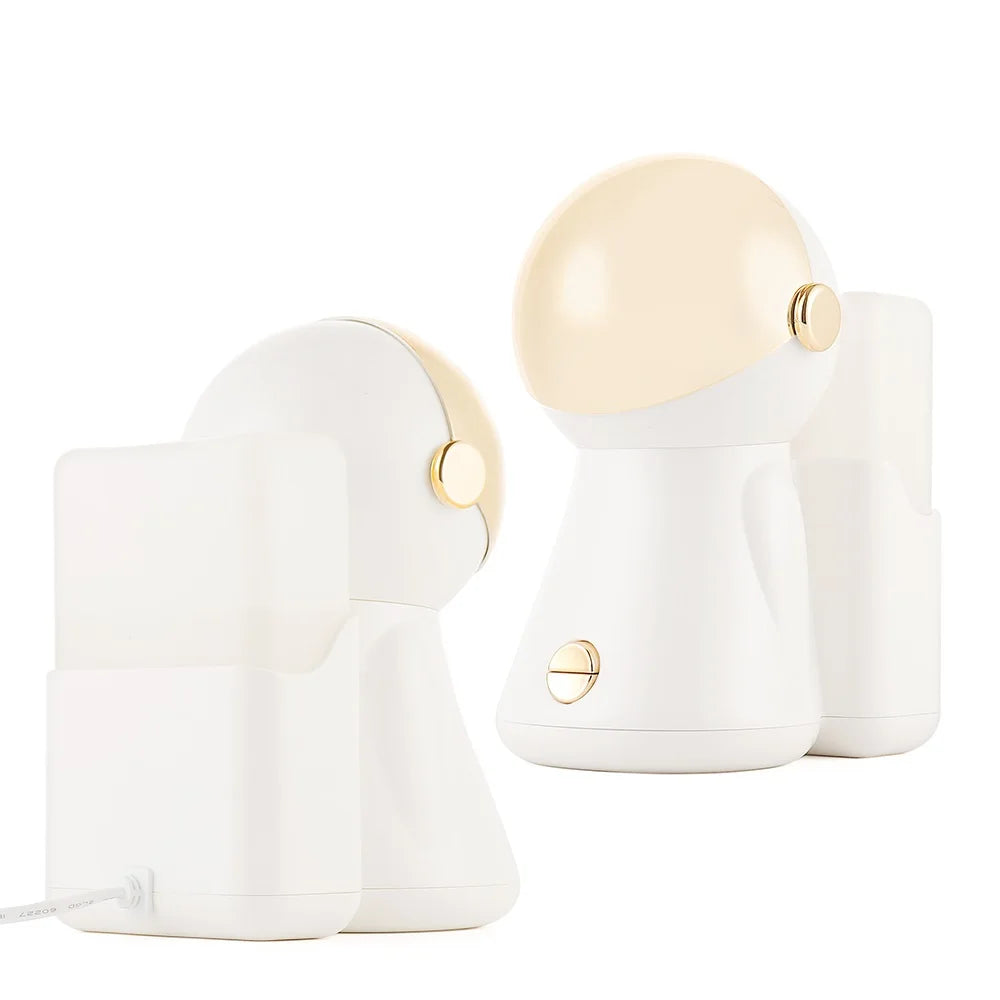 White and gold astronaut-style facial steamer for home skin care with nano hot spray and light therapy functionality.