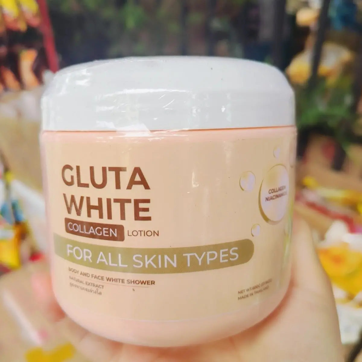 Gluta White Collagen lotion in a cylindrical, pale peach plastic jar with a white screw-top lid, for face and body.