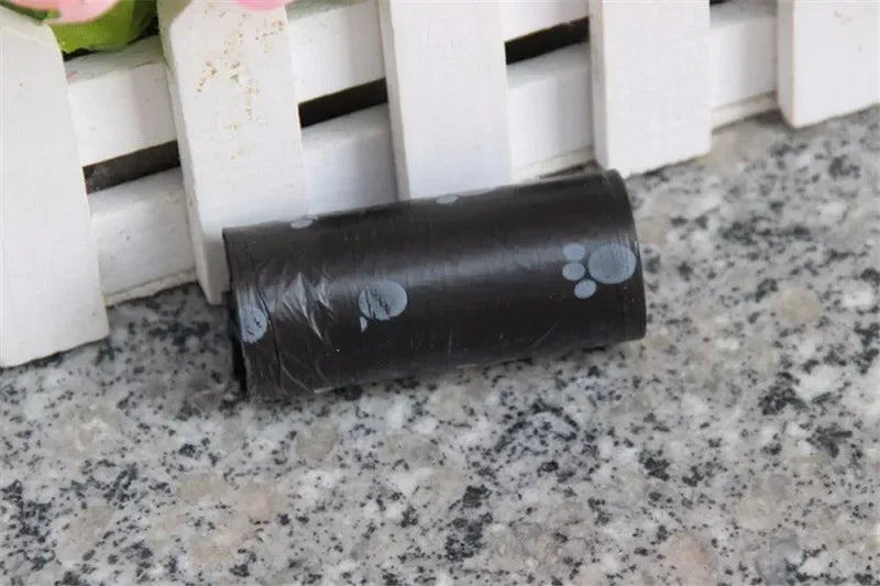 Black leak-proof dog poop bag roll with cute paw prints for easy, mess-free pet waste cleanup.