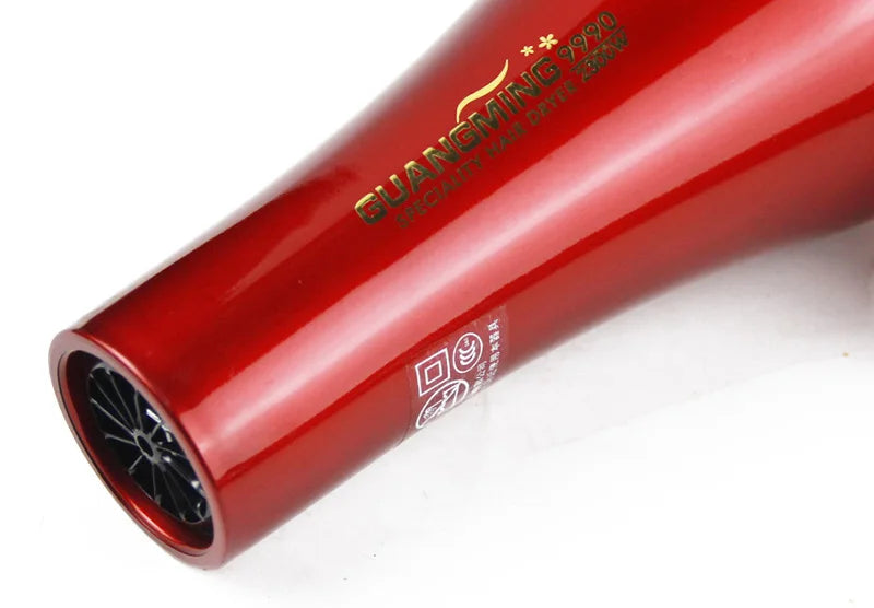 Red professional 2300W Guangming 9990 salon hair dryer with glossy finish and durable barrel design.