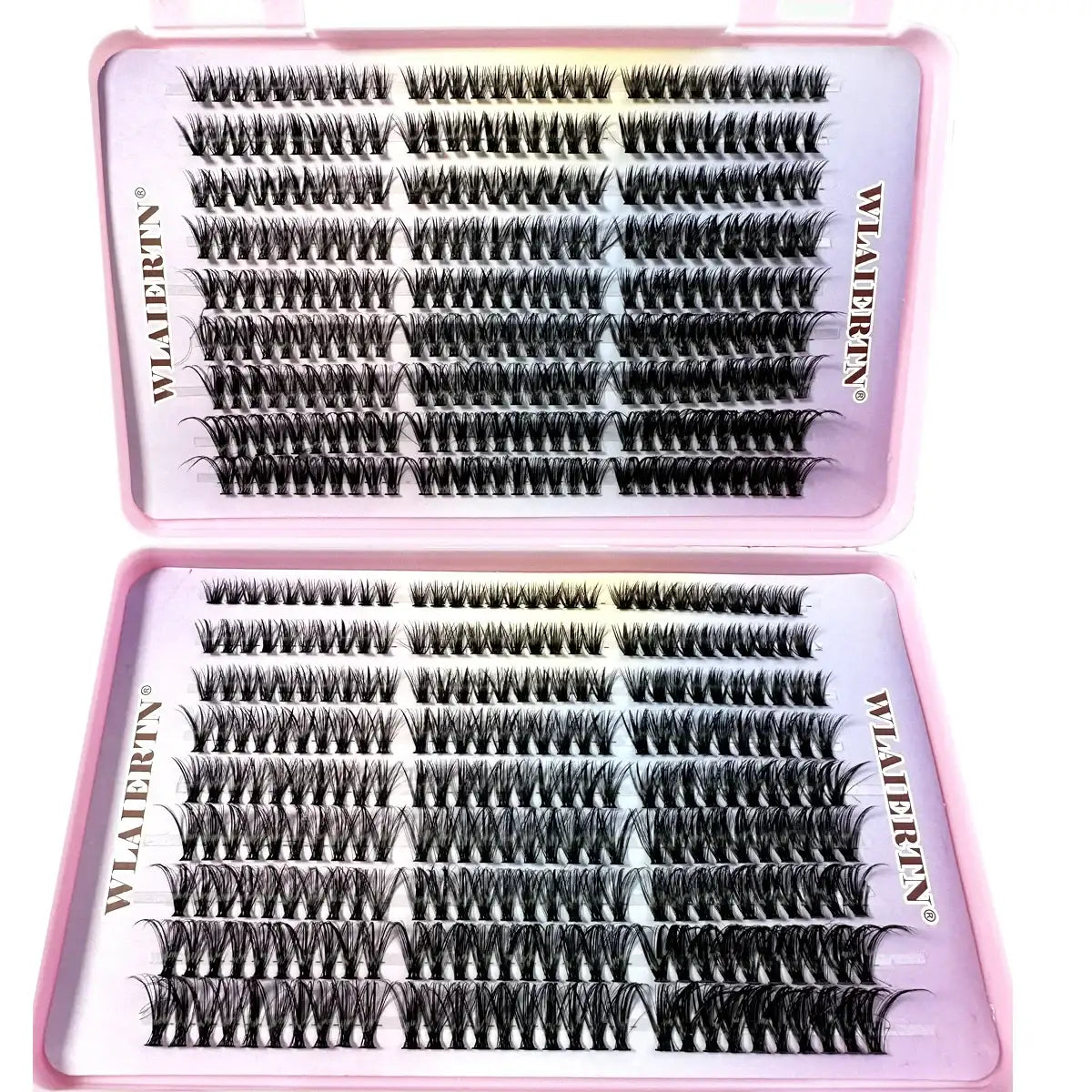 Rows of individual black synthetic eyelash clusters arranged in a rectangular pink plastic storage case.