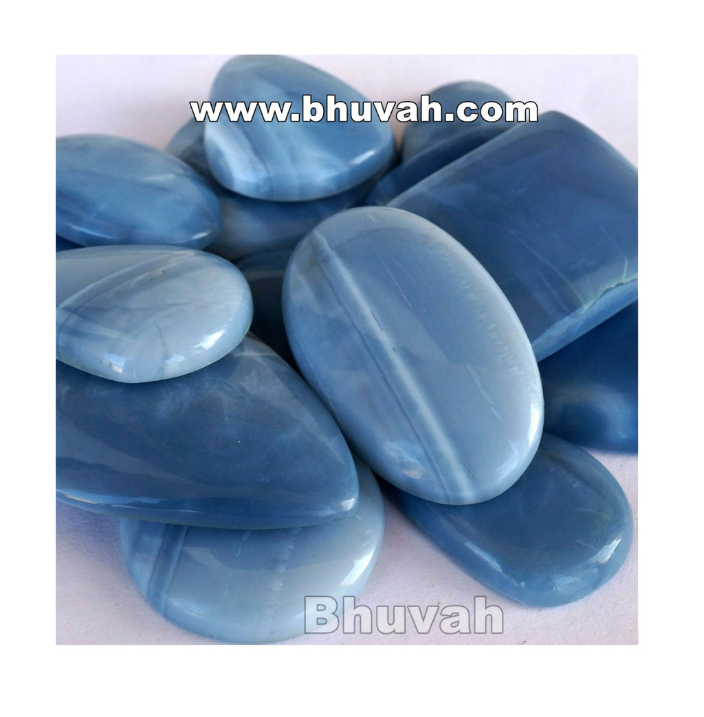 Blue opal cabochon gemstones, close-up oval stones in light and dark blue