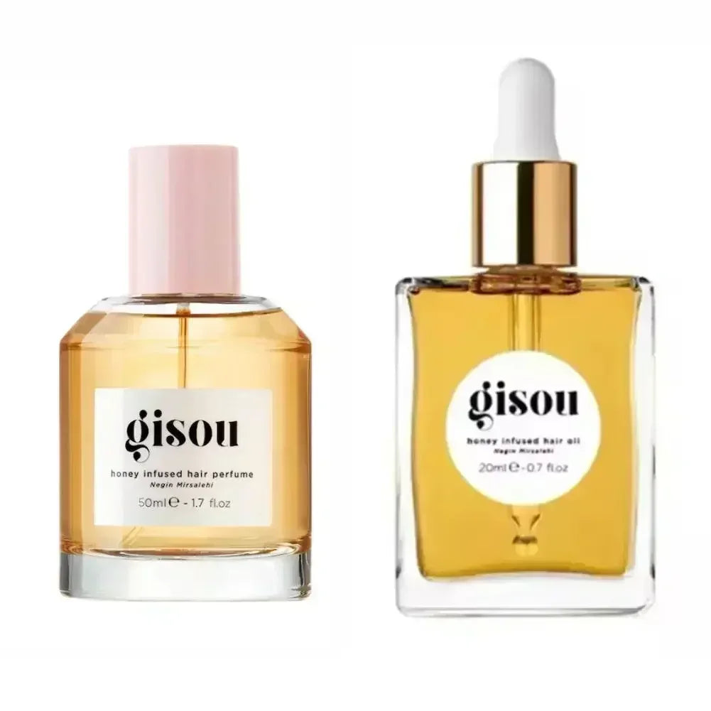Gisou honey-infused hair perfume and hair oil in glass bottles with amber liquid and golden labels.