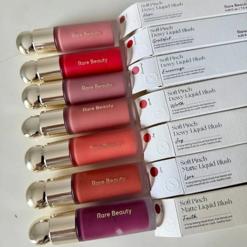 Rare Beauty liquid lip collection in diverse matte shades with smooth, hydrating textures and elegant gold-capped vials.