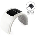 White arched PDT LED light therapy mask with black top control panel and AU power plug attachment.