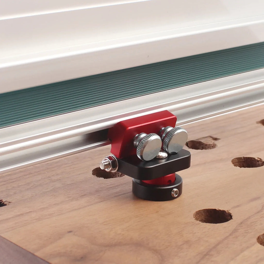 Adjustable track saw hinge dog clamp, red and black with mounting screws on rail