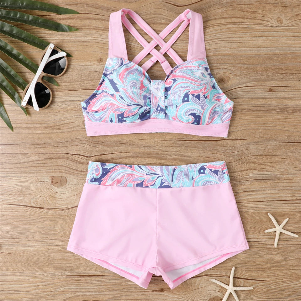 Tidesmit pink high-waist bikini set with a paisley print crop top, cross-back straps, and matching athletic shorts.