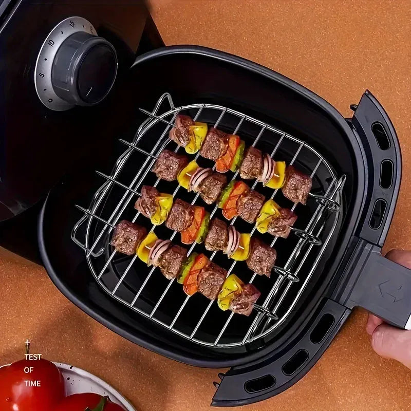 Square air fryer grilling rack with four shish-style skewers, holding grilled meat and vegetables
