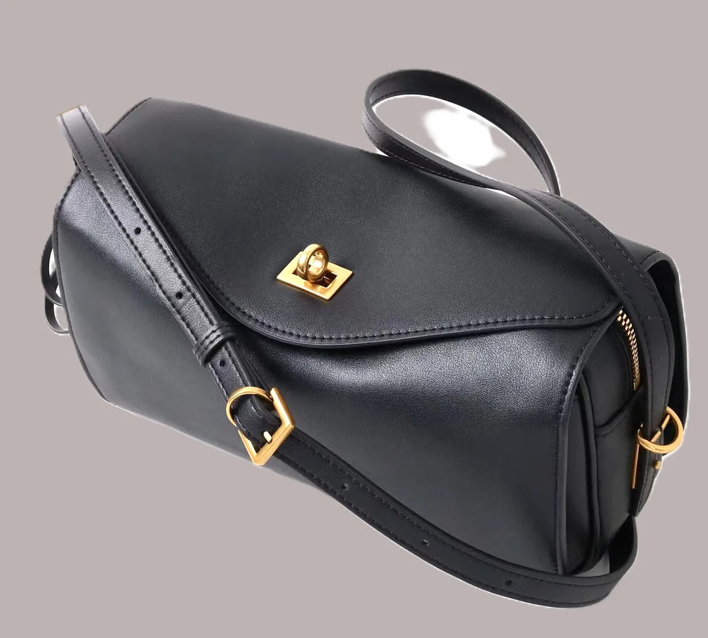 Royaa black genuine leather designer shoulder bag with elegant gold hardware, adjustable strap, and zip closure.