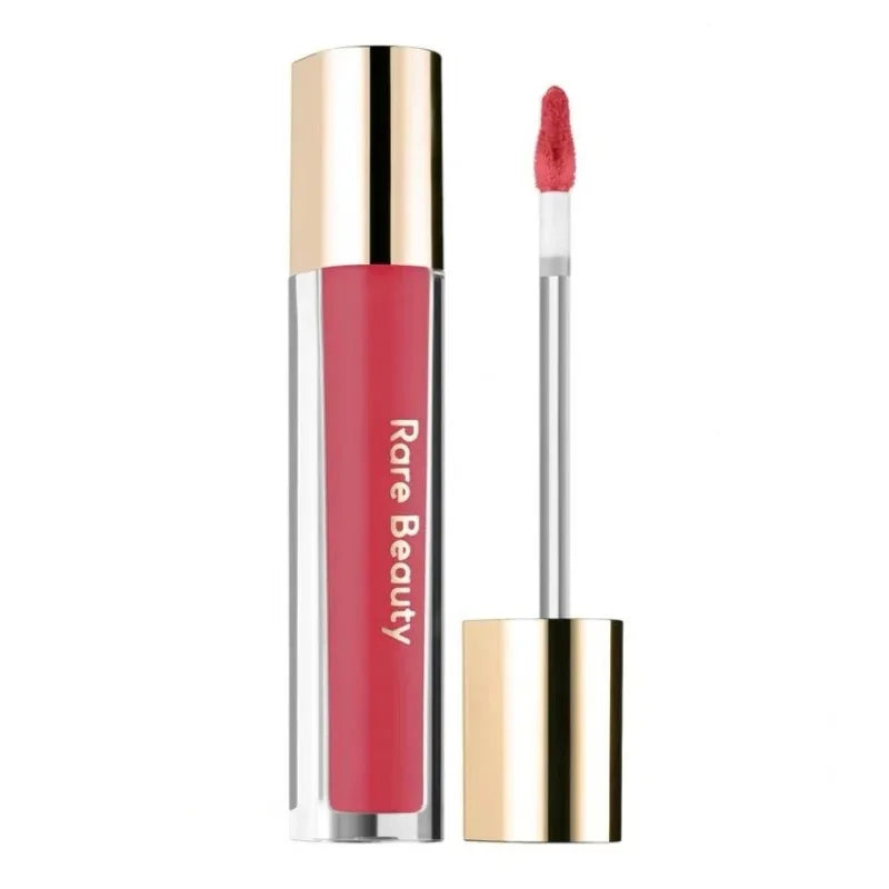 Rare Beauty Soft Pinch Tinted Lip Oil with doe-foot applicator in a vibrant pink shade for a moisturizing glossy finish.